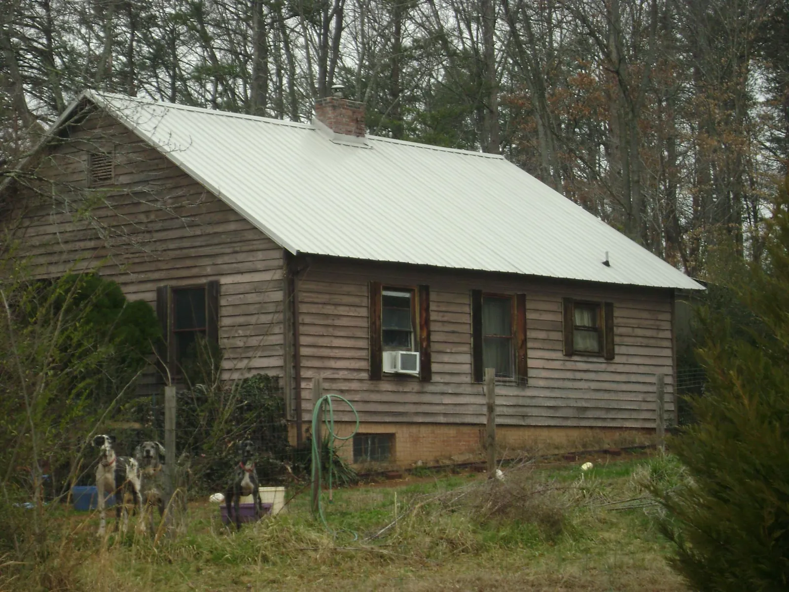 White metal roof on an old wood sided farmhouse, from a Metal Roof Installation job in Albright
